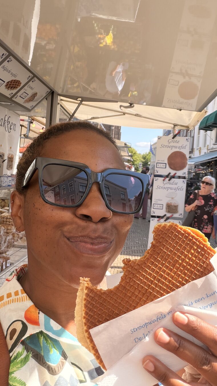 Brandi holding a fresh stroopwafel at a market stall